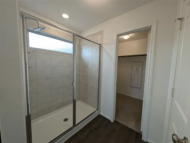a bathroom with a glass shower door
