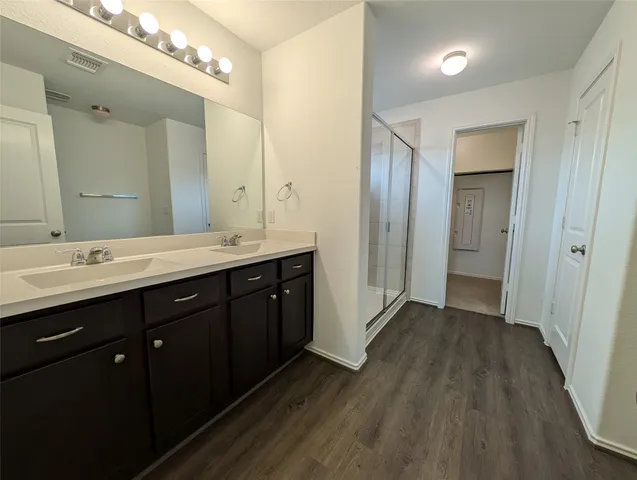 a spacious bathroom with a double vanity sink and a mirror