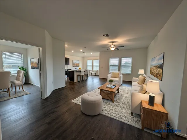 a living room with furniture and a chandelier