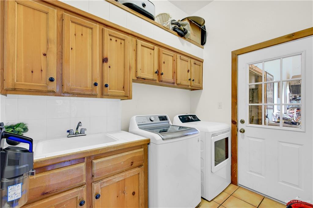 2701 Easy Street Edinburg, TX 78539 - Photo 17 of 22 a utility room with stainless steel appliances granite countertop a sink a stove and a window