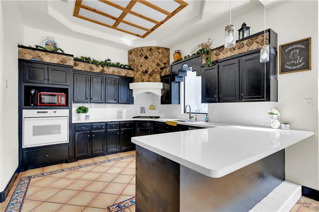 2701 Easy Street Edinburg, TX 78539 - Photo 6 of 22 a kitchen with a sink a stove and cabinets