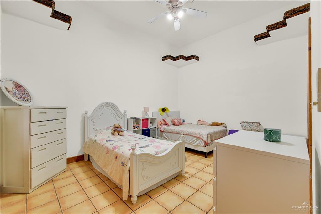 2701 Easy Street Edinburg, TX 78539 - Photo 10 of 22 a bed room with a bed and a table