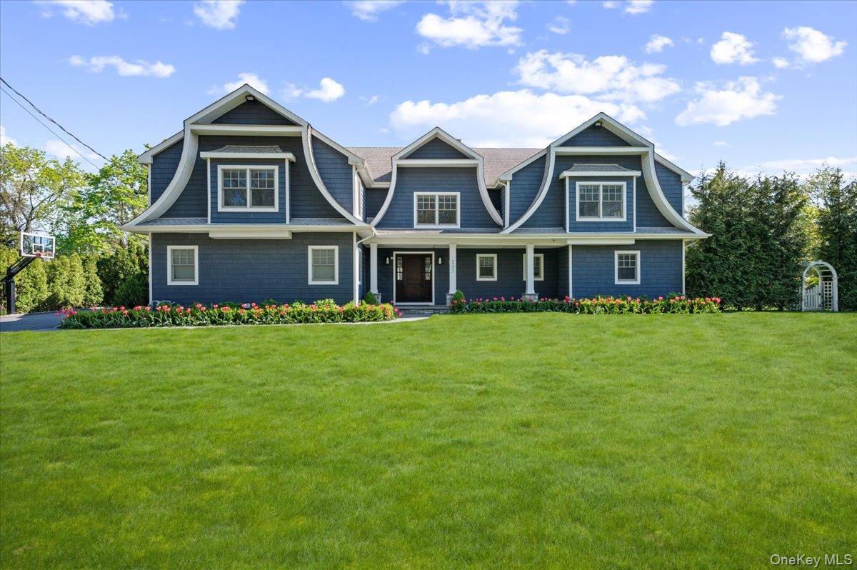 a front view of a house with a garden