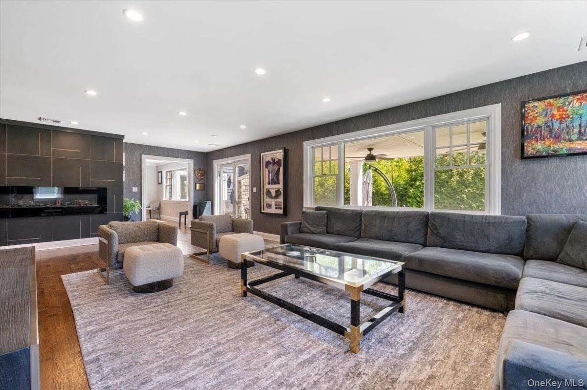205 Hewlett Neck Road Woodmere, NY 11598 - Photo 18 of 50 a living room with furniture and a flat screen tv