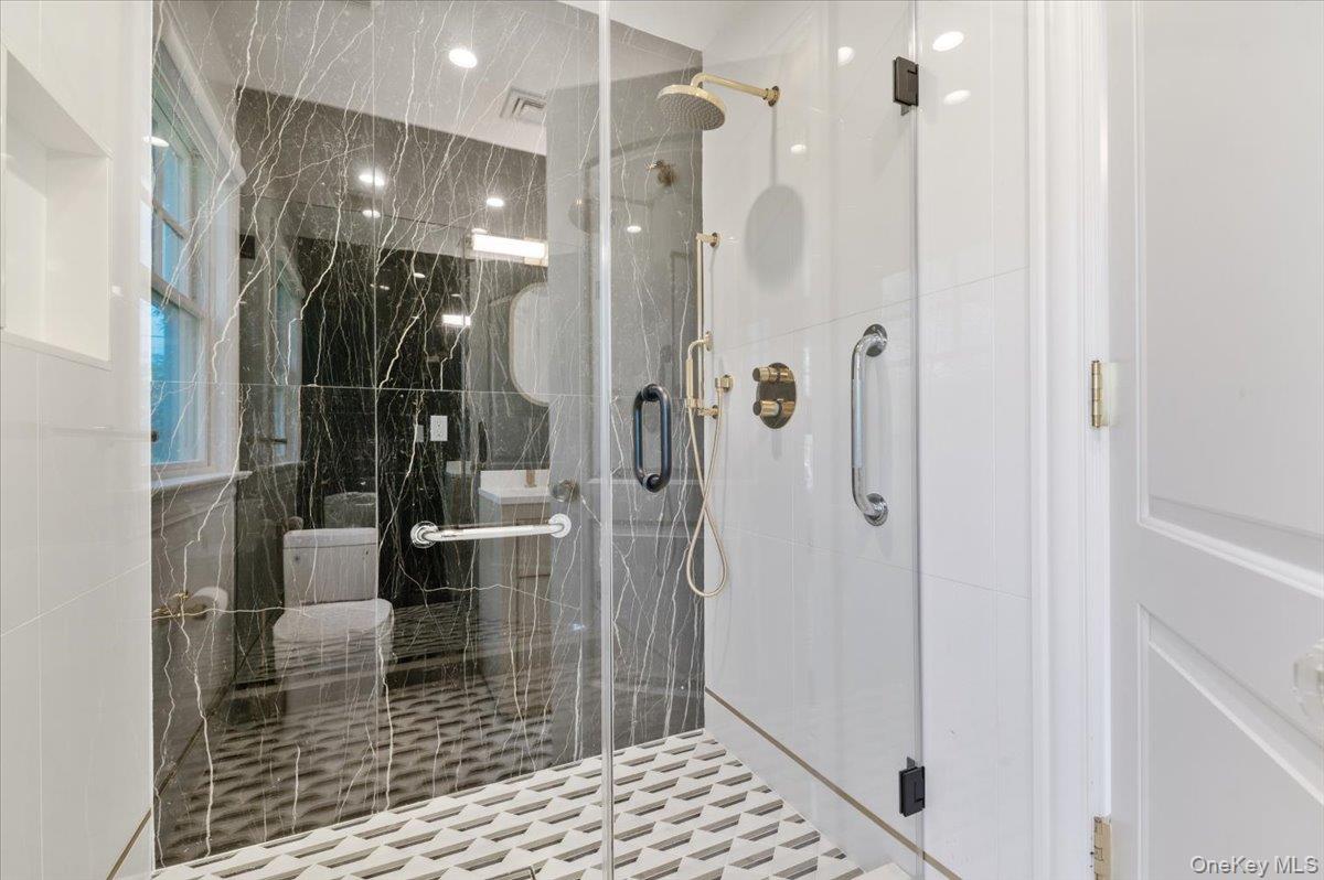 205 Hewlett Neck Road Woodmere, NY 11598 - Photo 22 of 50 a bathroom with a glass shower door
