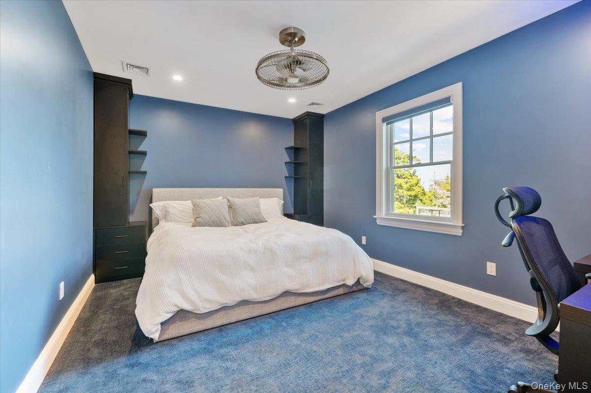 205 Hewlett Neck Road Woodmere, NY 11598 - Photo 27 of 50 a bedroom with a bed and a window