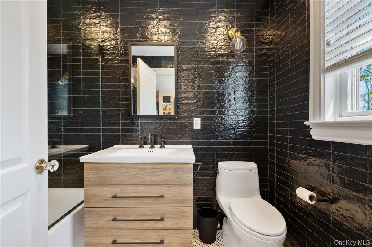 205 Hewlett Neck Road Woodmere, NY 11598 - Photo 30 of 50 a bathroom with a sink toilet and mirror
