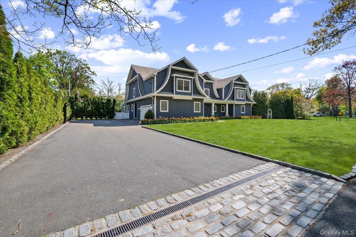 205 Hewlett Neck Road Woodmere, NY 11598 - Photo 3 of 50 a front view of a house with a yard