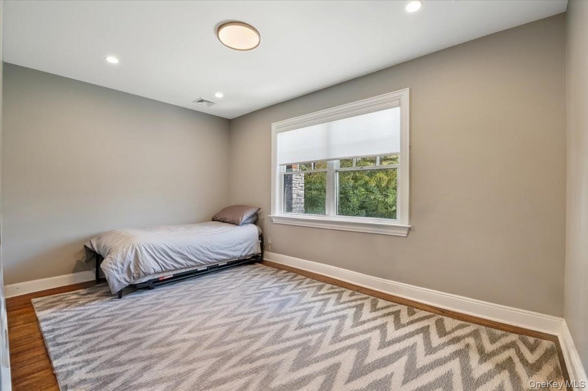 205 Hewlett Neck Road Woodmere, NY 11598 - Photo 33 of 50 a bedroom with a bed and a window