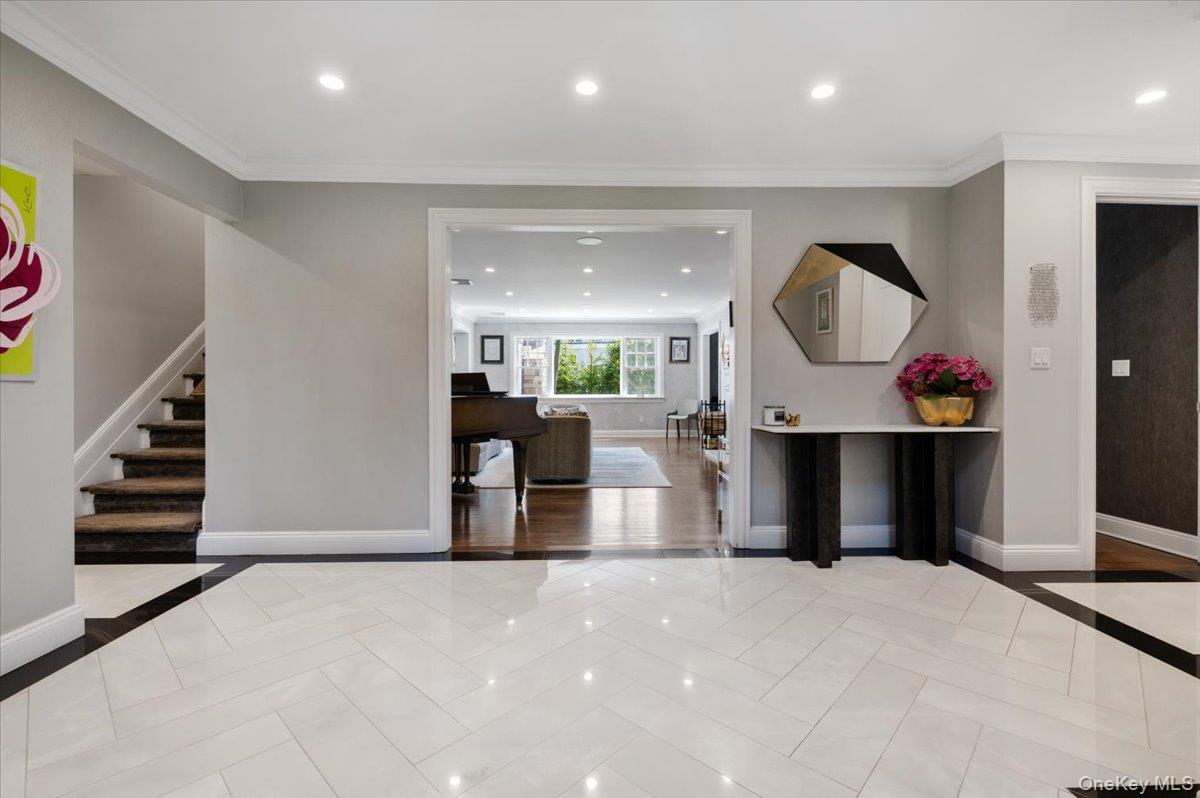 205 Hewlett Neck Road Woodmere, NY 11598 - Photo 4 of 50 a view of a living room a fireplace with furniture and stairs