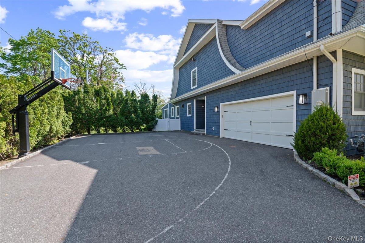 205 Hewlett Neck Road Woodmere, NY 11598 - Photo 44 of 50 a view of a house with a yard and garage
