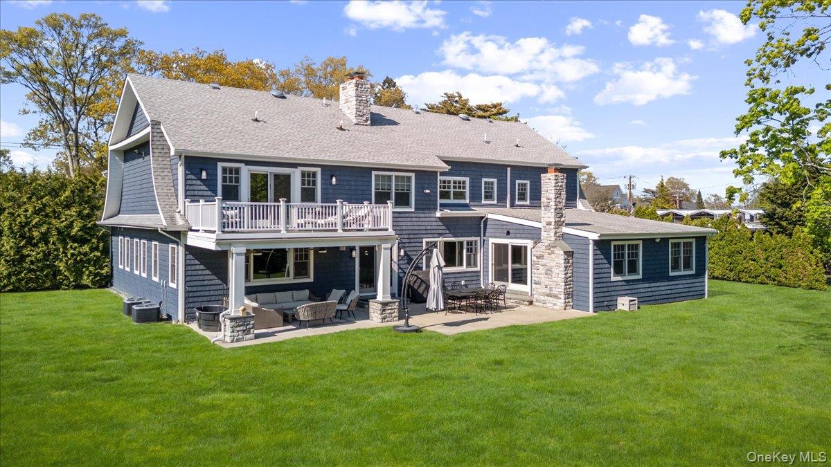 205 Hewlett Neck Road Woodmere, NY 11598 - Photo 45 of 50 a front view of house with yard and outdoor seating