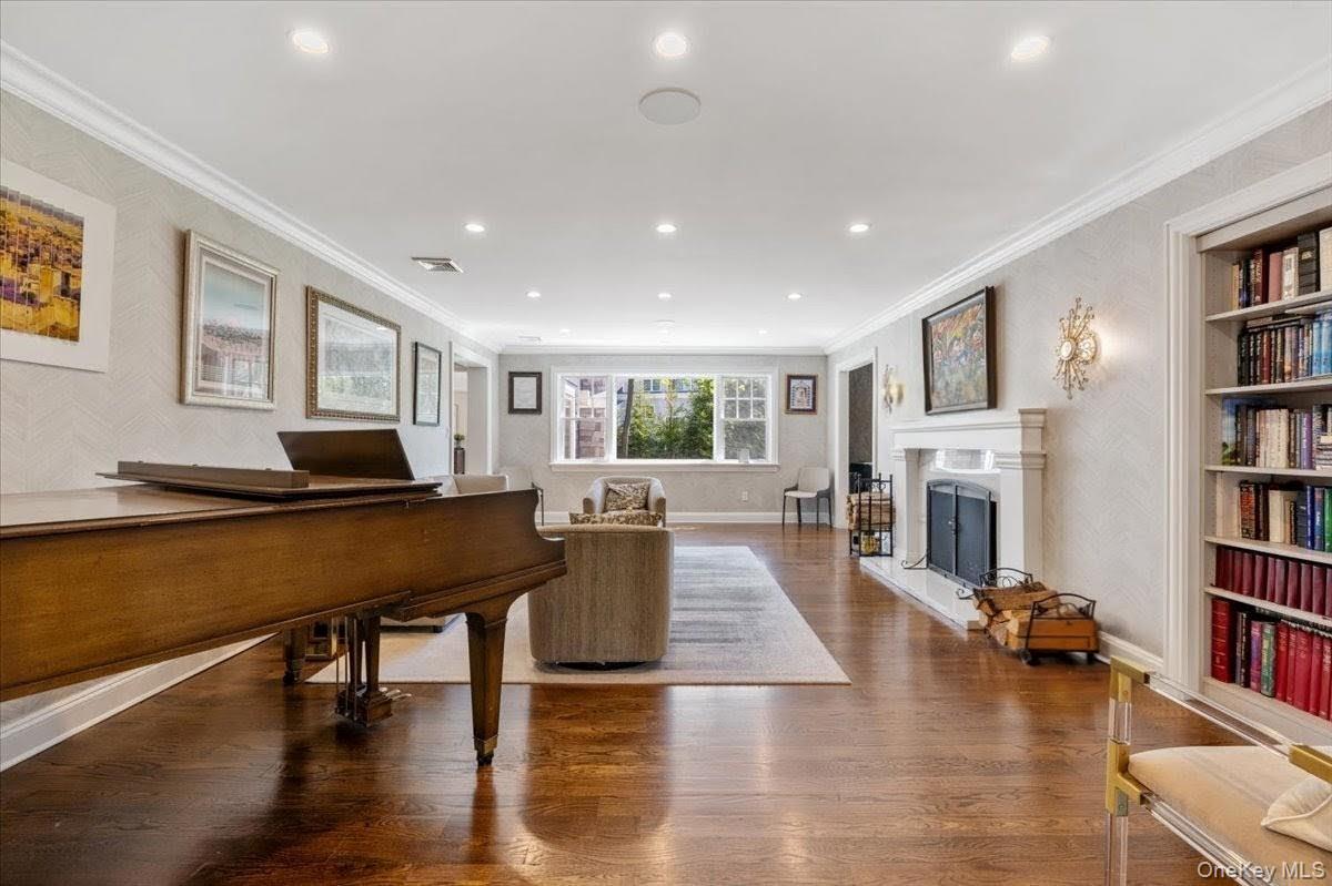 205 Hewlett Neck Road Woodmere, NY 11598 - Photo 6 of 50 a living room with furniture and a book shelf