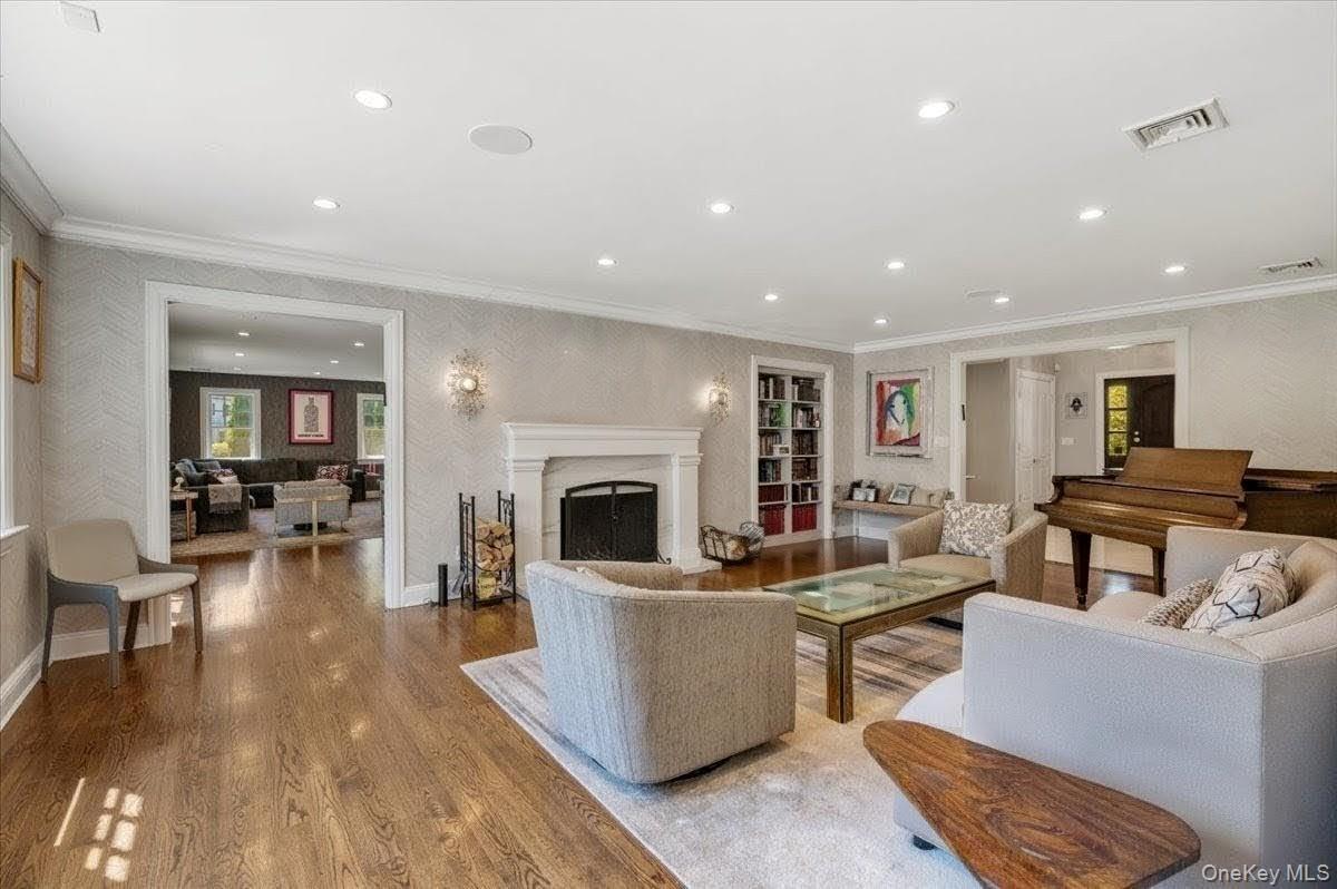 205 Hewlett Neck Road Woodmere, NY 11598 - Photo 7 of 50 a living room with furniture a fireplace and a flat screen tv