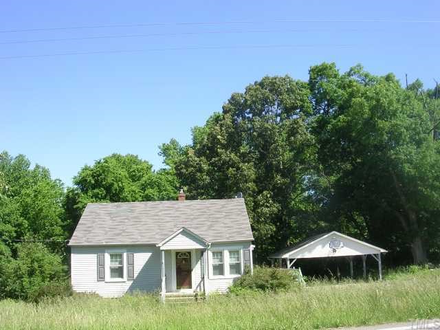 1719 Virgilina Road Roxboro, NC 27573 - Photo 1 of 3 an aerial view of a house with yard and outdoor seating