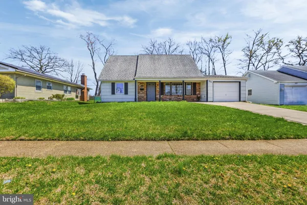 a front view of a house with a garden and yard