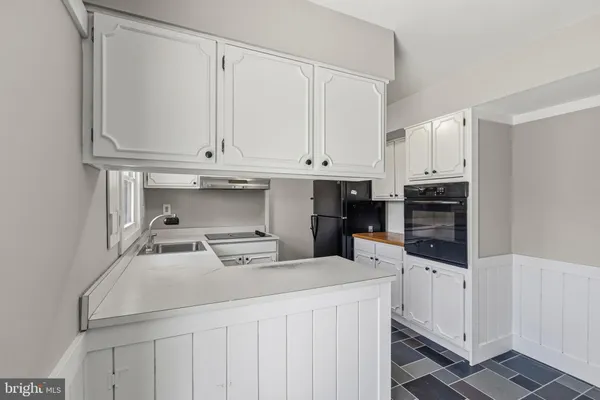 a kitchen with stainless steel appliances a sink and cabinets