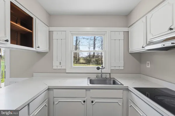 a kitchen with a sink and cabinets
