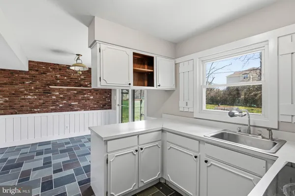 a kitchen with a sink and a window