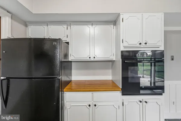 a kitchen with refrigerator and window