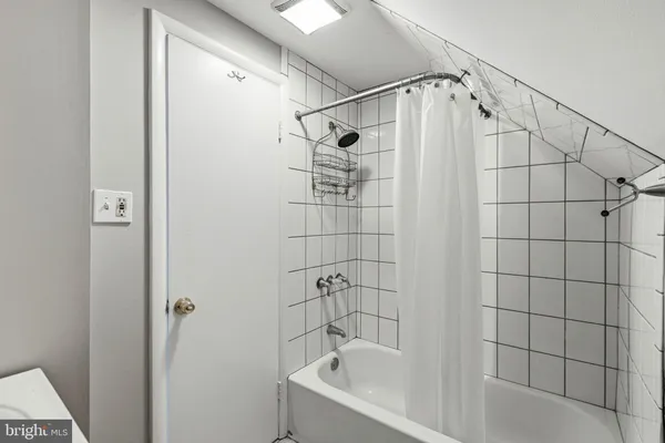 a bathroom with a shower and a bathtub