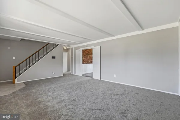 a view of an empty room with stairs