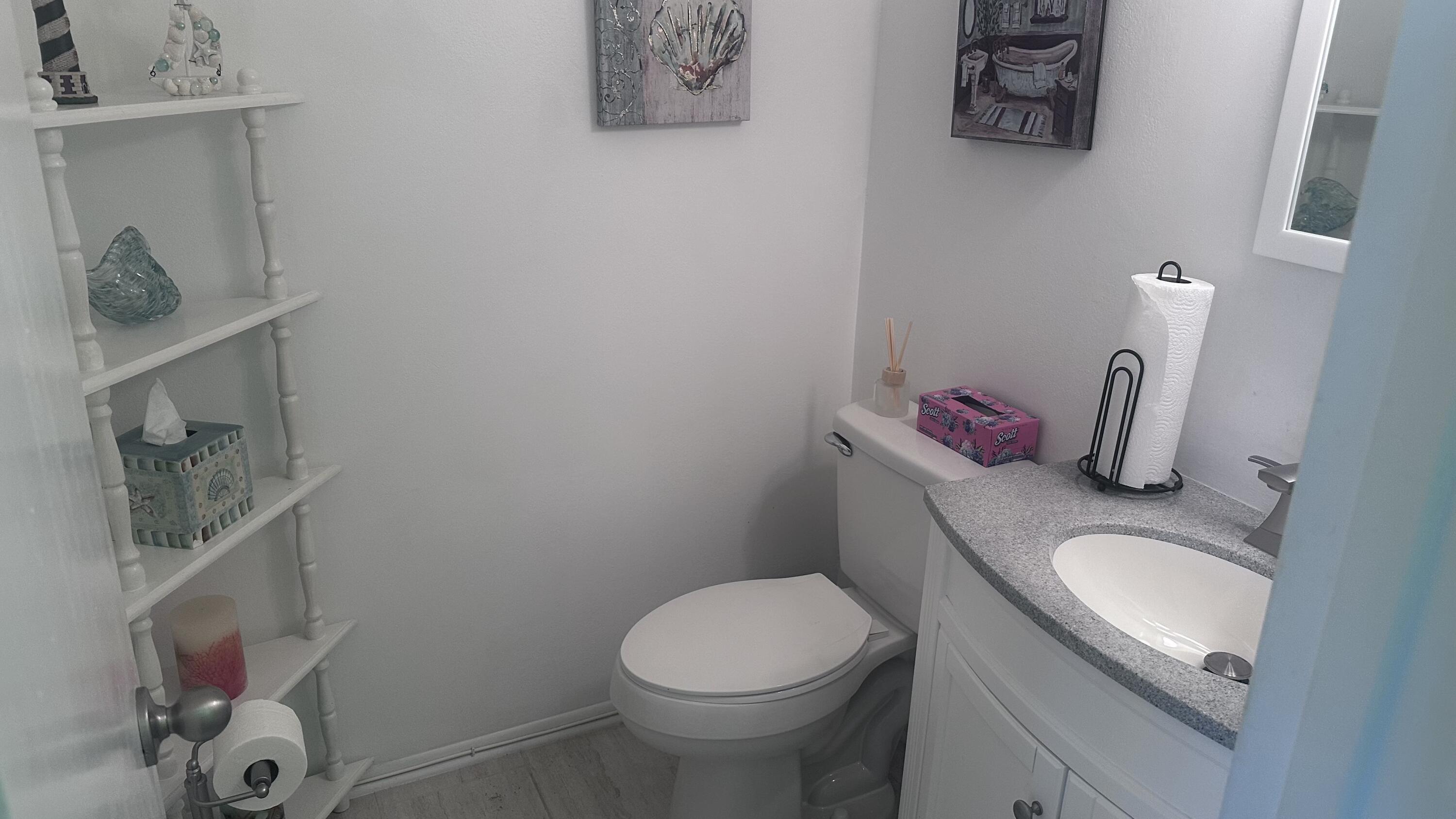 2600 Southeast Ocean Boulevard, Unit D12 Stuart, FL 34996 - Photo 6 of 15 a bathroom with a granite countertop sink and a toilet