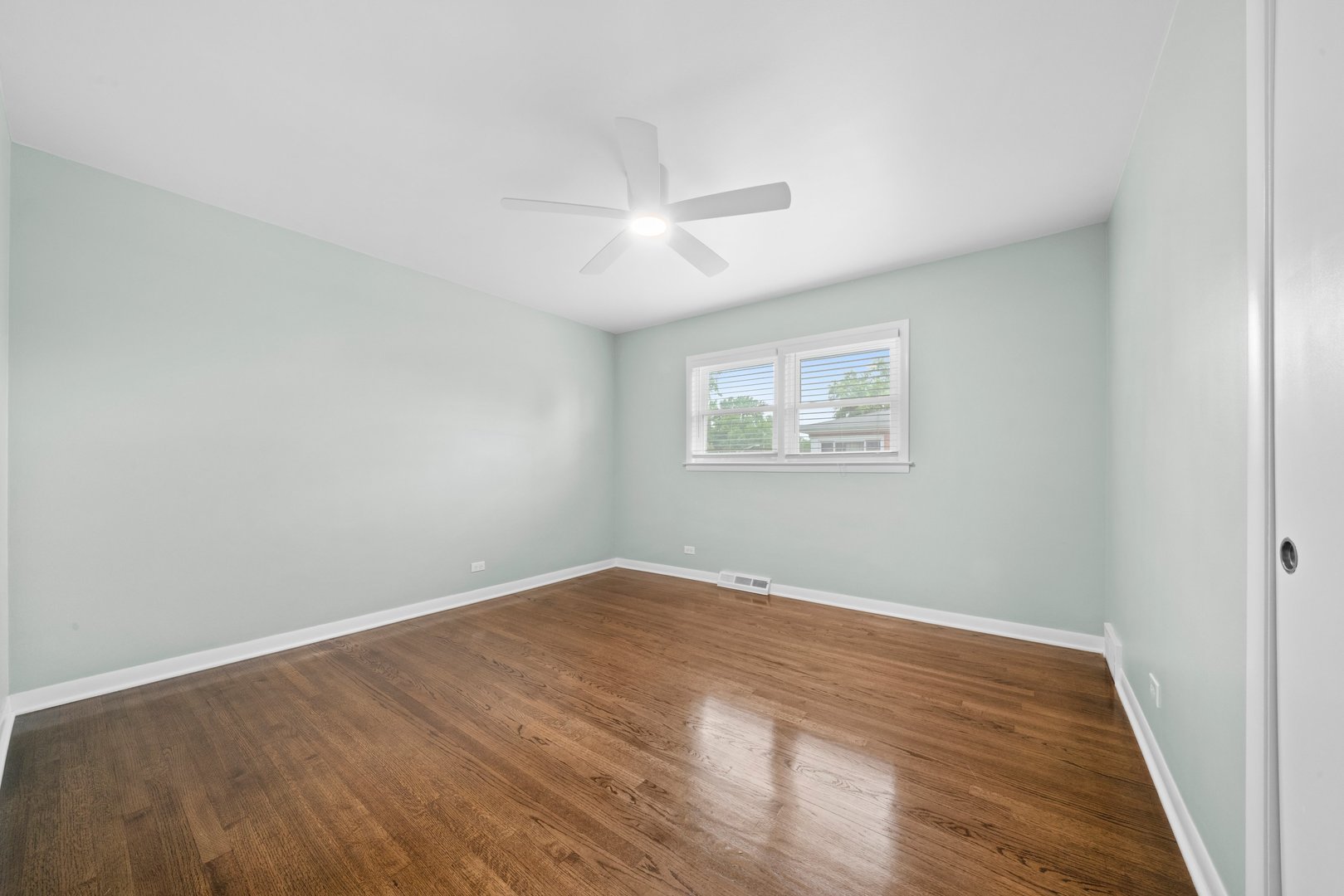 10537 Austin Avenue, Unit 2 Chicago Ridge, IL 60415 - Photo 11 of 19 a view of an empty room with wooden floor and a window