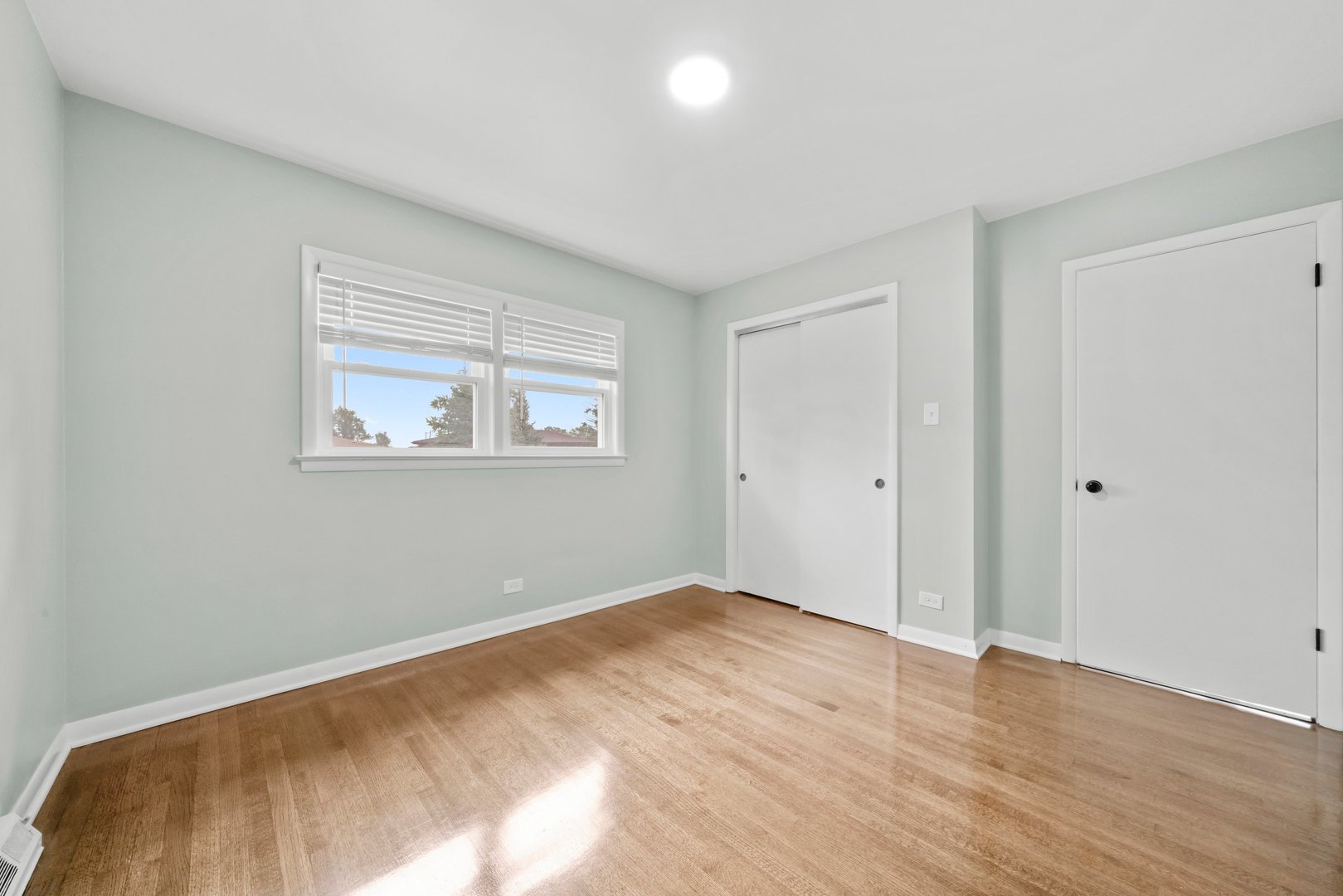 10537 Austin Avenue, Unit 2 Chicago Ridge, IL 60415 - Photo 16 of 19 a view of empty room with wooden floor and fan