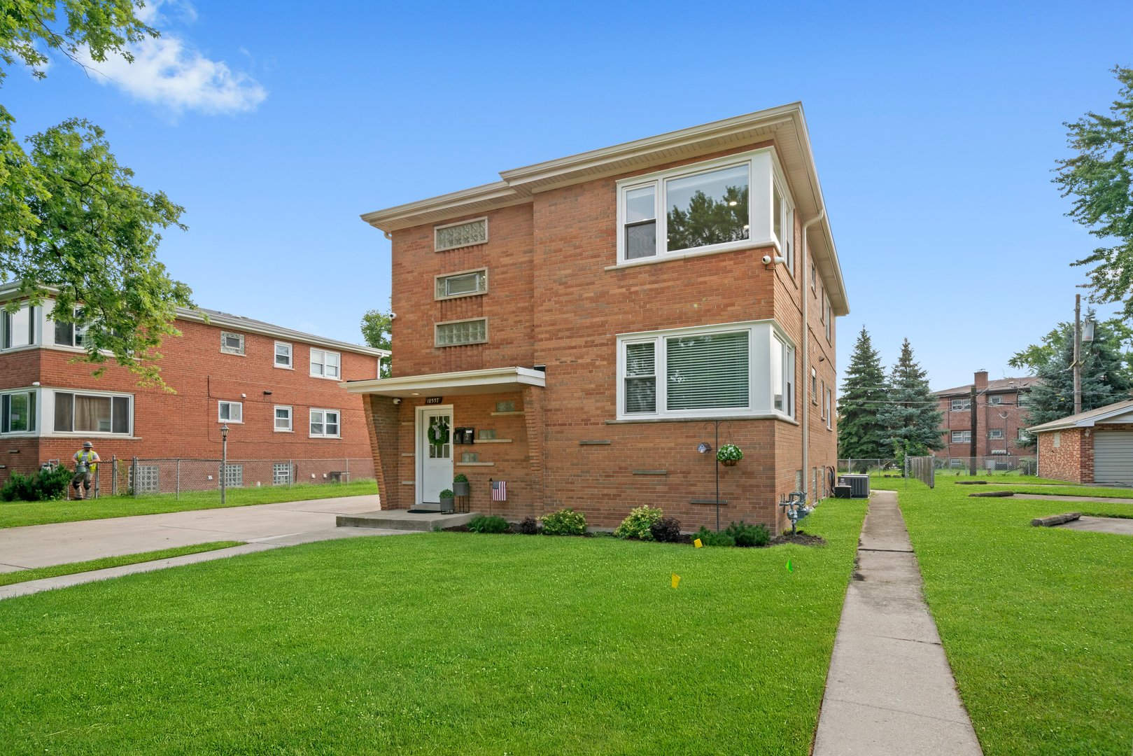 10537 Austin Avenue, Unit 2 Chicago Ridge, IL 60415 - Photo 18 of 19 a front view of a house with garden