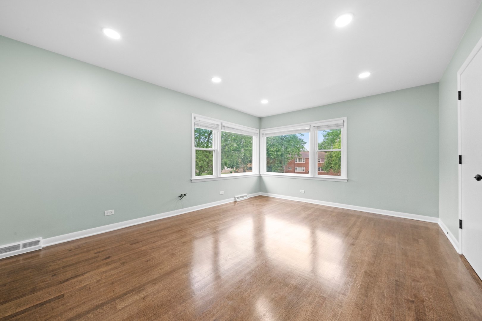 10537 Austin Avenue, Unit 2 Chicago Ridge, IL 60415 - Photo 3 of 19 a view of an empty room with wooden floor and a window