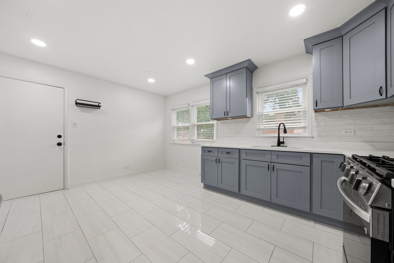 10537 Austin Avenue, Unit 2 Chicago Ridge, IL 60415 - Photo 6 of 19 a kitchen with a sink a stove and cabinets