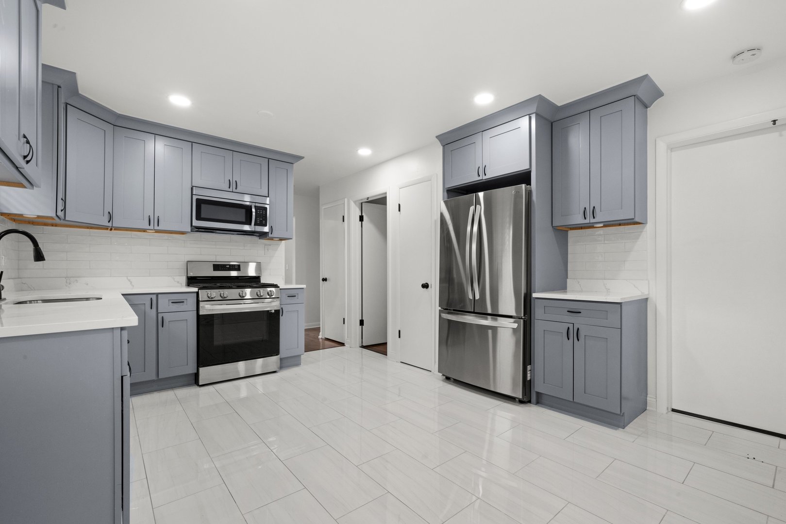10537 Austin Avenue, Unit 2 Chicago Ridge, IL 60415 - Photo 8 of 19 a kitchen with stainless steel appliances a refrigerator stove and sink