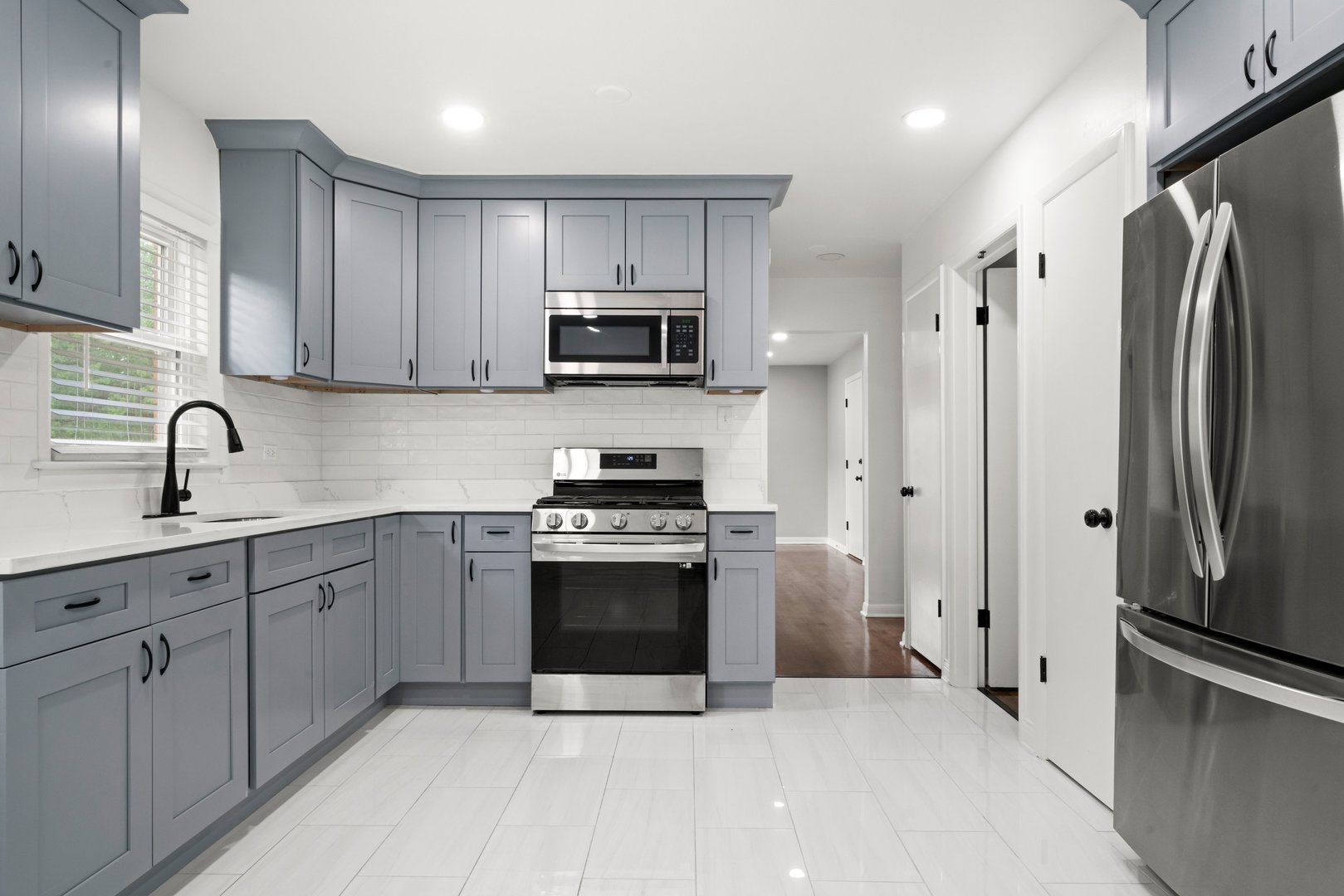 10537 Austin Avenue, Unit 2 Chicago Ridge, IL 60415 - Photo 9 of 19 a kitchen with stainless steel appliances granite countertop a refrigerator stove a sink and dishwasher with wooden floor