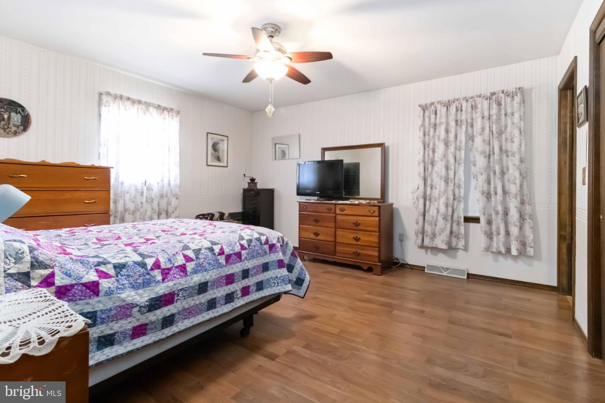 1712 Newville Road Carlisle, PA 17015 - Photo 19 of 32 a bedroom with a bed and a flat screen tv