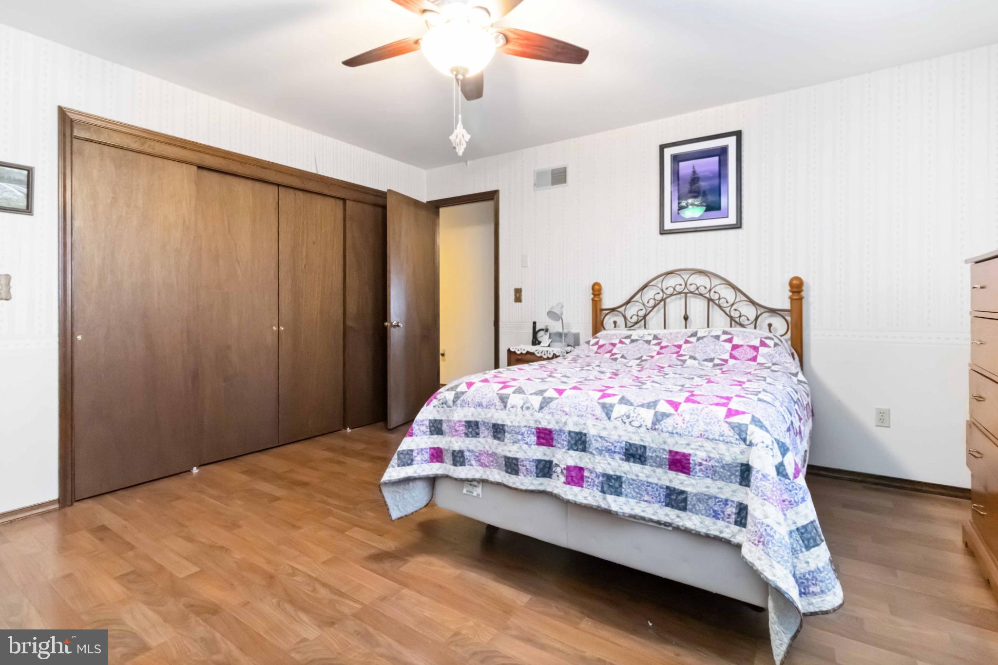 1712 Newville Road Carlisle, PA 17015 - Photo 20 of 32 a bedroom with a bed and a chandelier