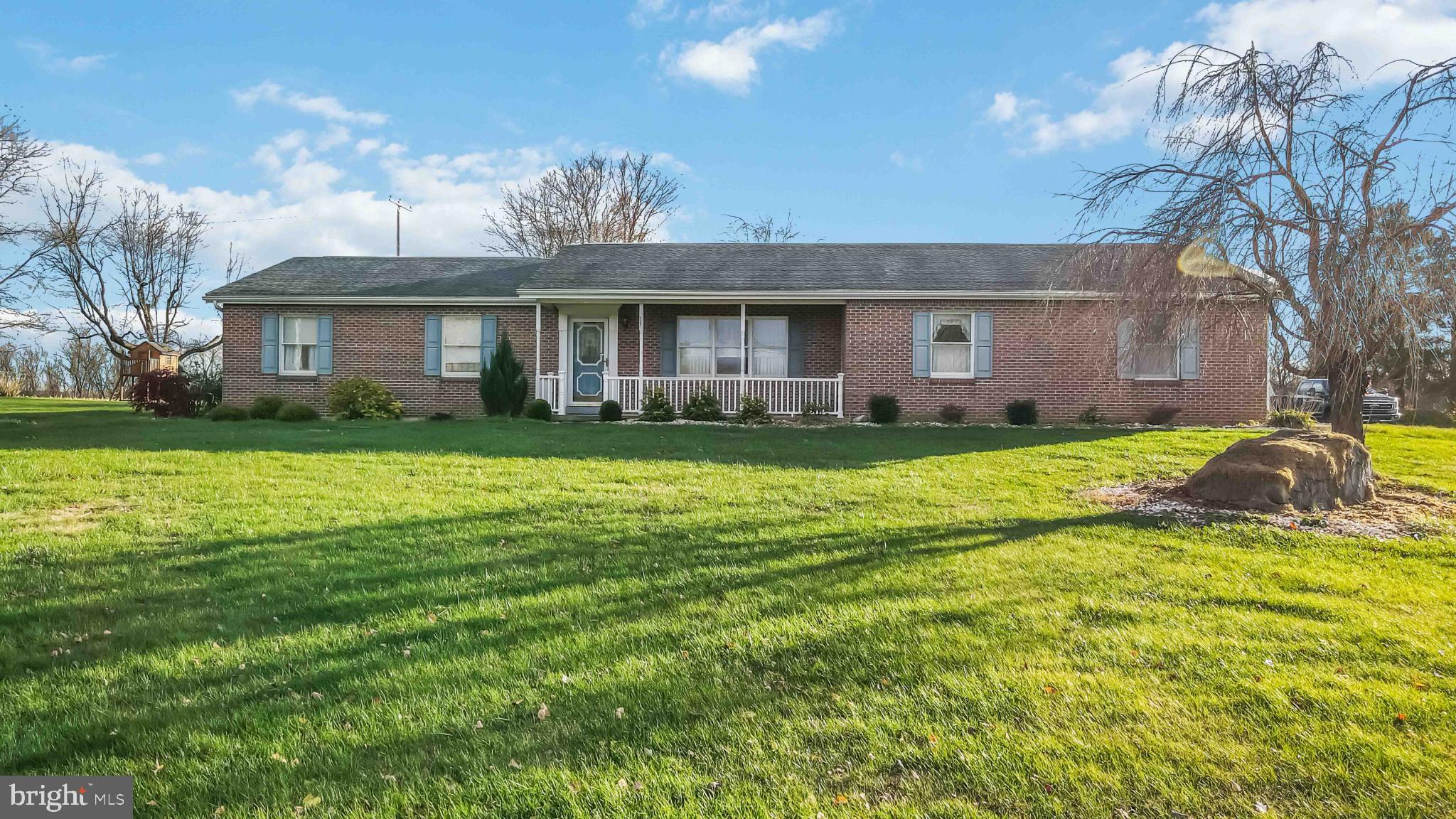 1712 Newville Road Carlisle, PA 17015 - Photo 2 of 32 a view of a house with a big yard and potted plants