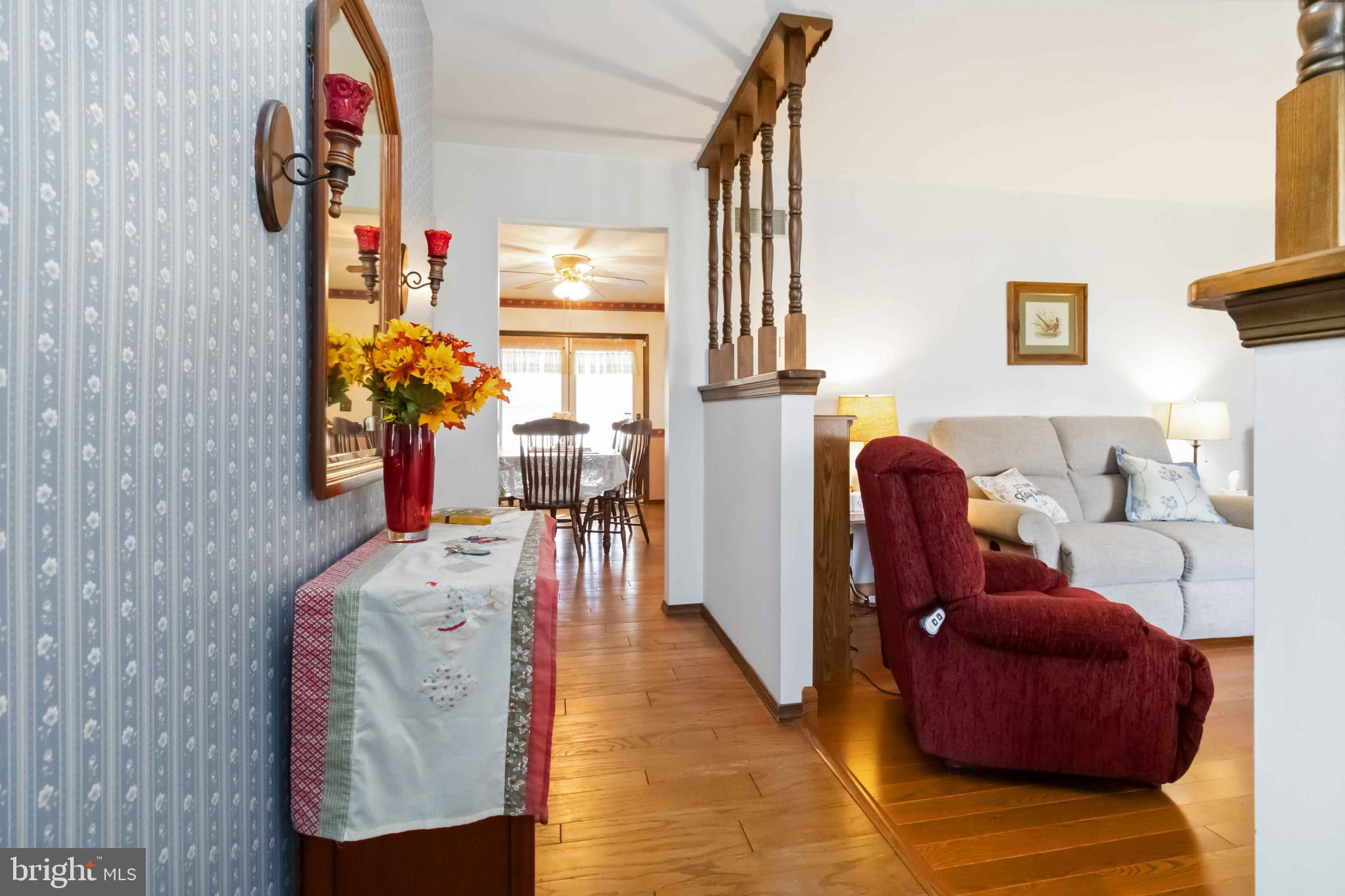 1712 Newville Road Carlisle, PA 17015 - Photo 8 of 32 a living room with furniture a rug and a fireplace