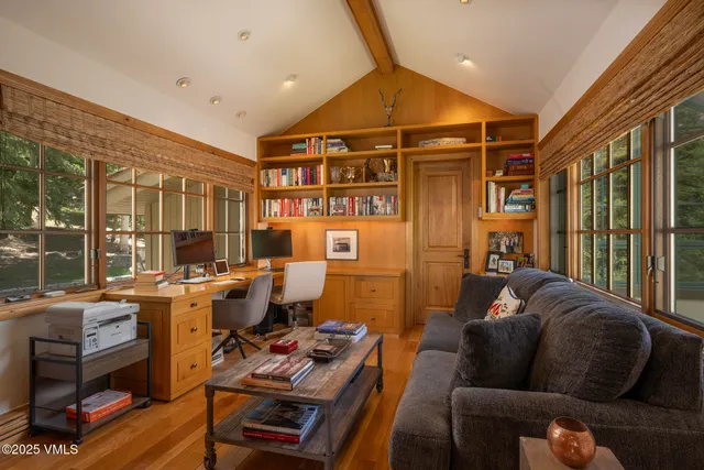 a living room with furniture and a floor to ceiling window