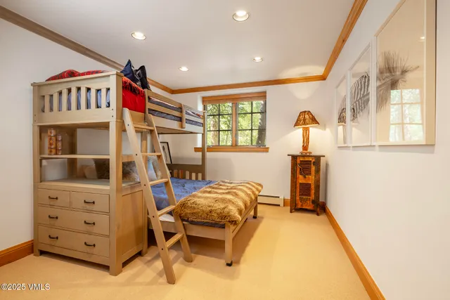 a bedroom with a bed and a chair in it