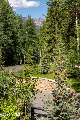 a view of a yard with wooden fence