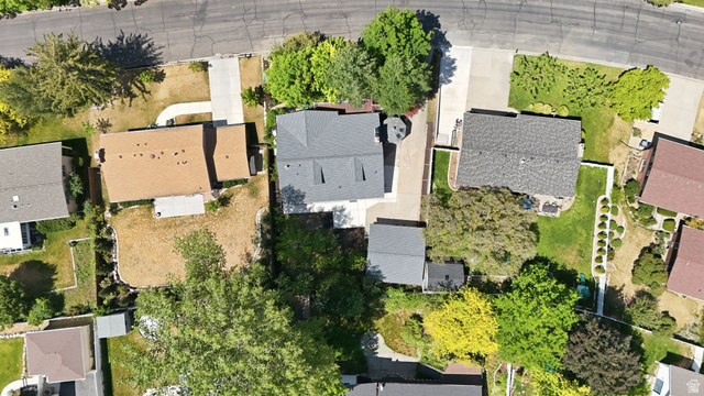 3120 North Apache Way Provo, UT 84604 - Photo 56 of 58 Property featuring a light brown shingle roof, a concrete driveway, and a partially landscaped backyard