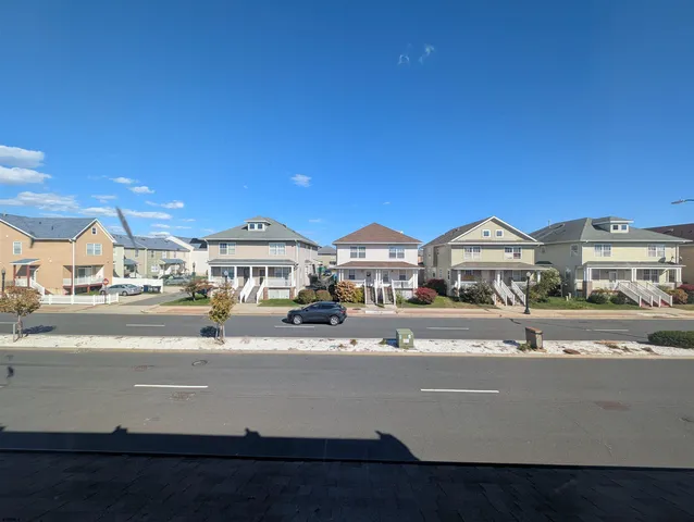 a view of multiple houses with a street