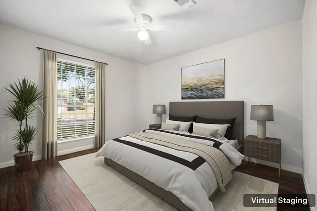 a bedroom with a large bed and a window