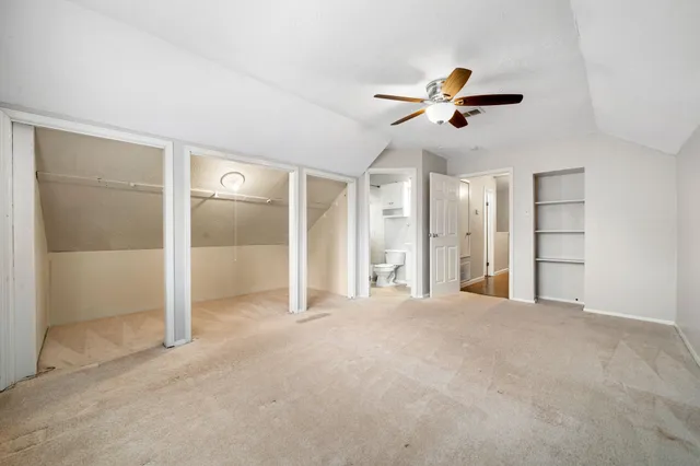 a view of empty room with ceiling fan
