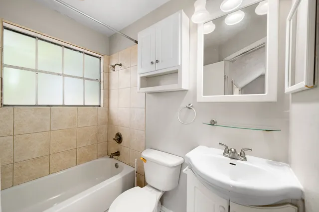 a bathroom with a sink a toilet and bathtub