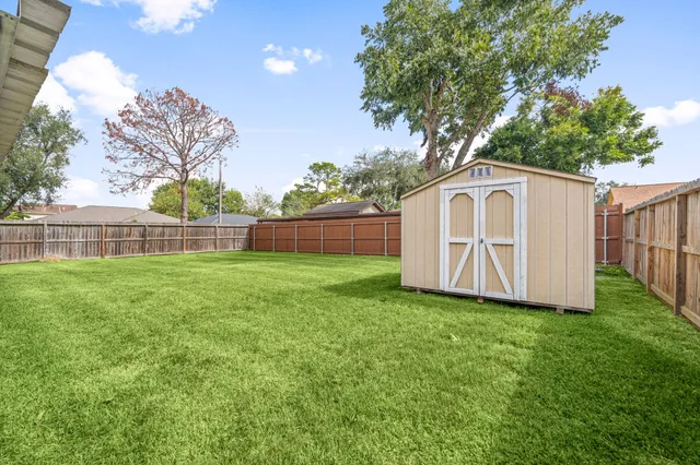 a view of yard with grass and a trees