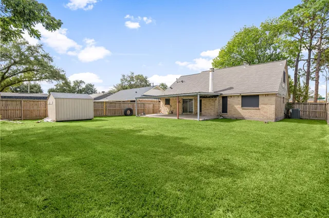 a front view of house with a garden