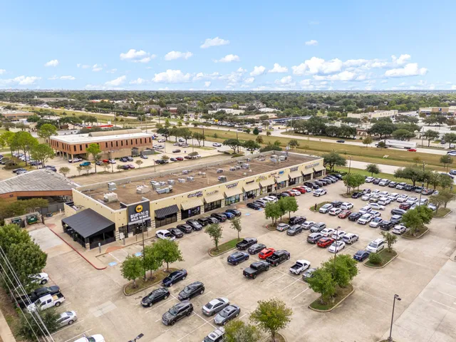an aerial view of a house with garden space and street view