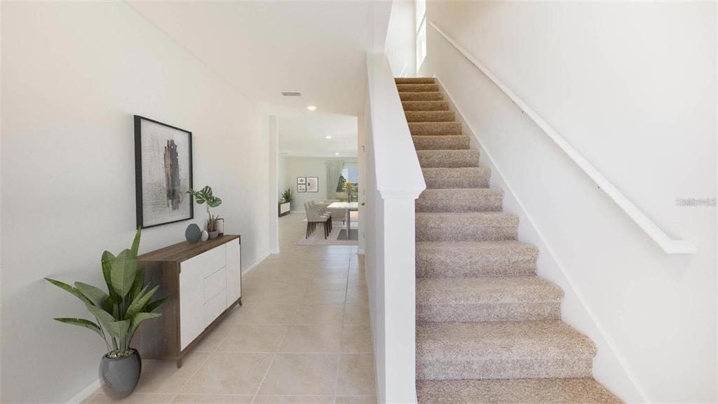 3022 Rock Sound Street Bradenton, FL 34208 - Photo 2 of 13 a view of staircase with white walls and frames on wall